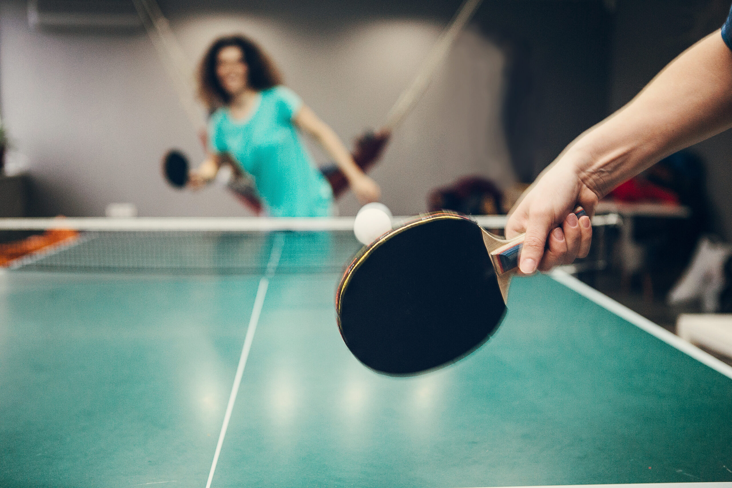 two people playing table tennis