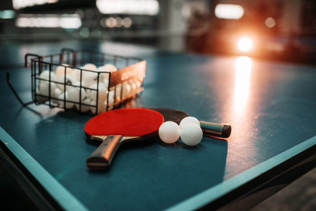 ping pong paddles and balls on table