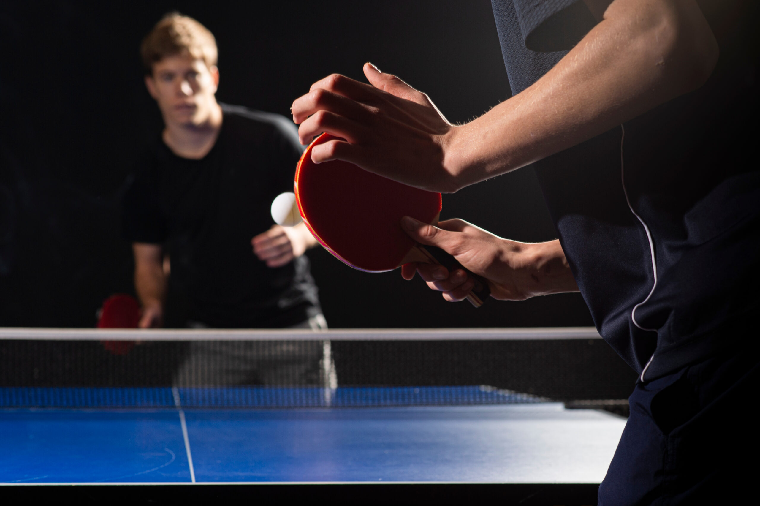 two men playing ping pong