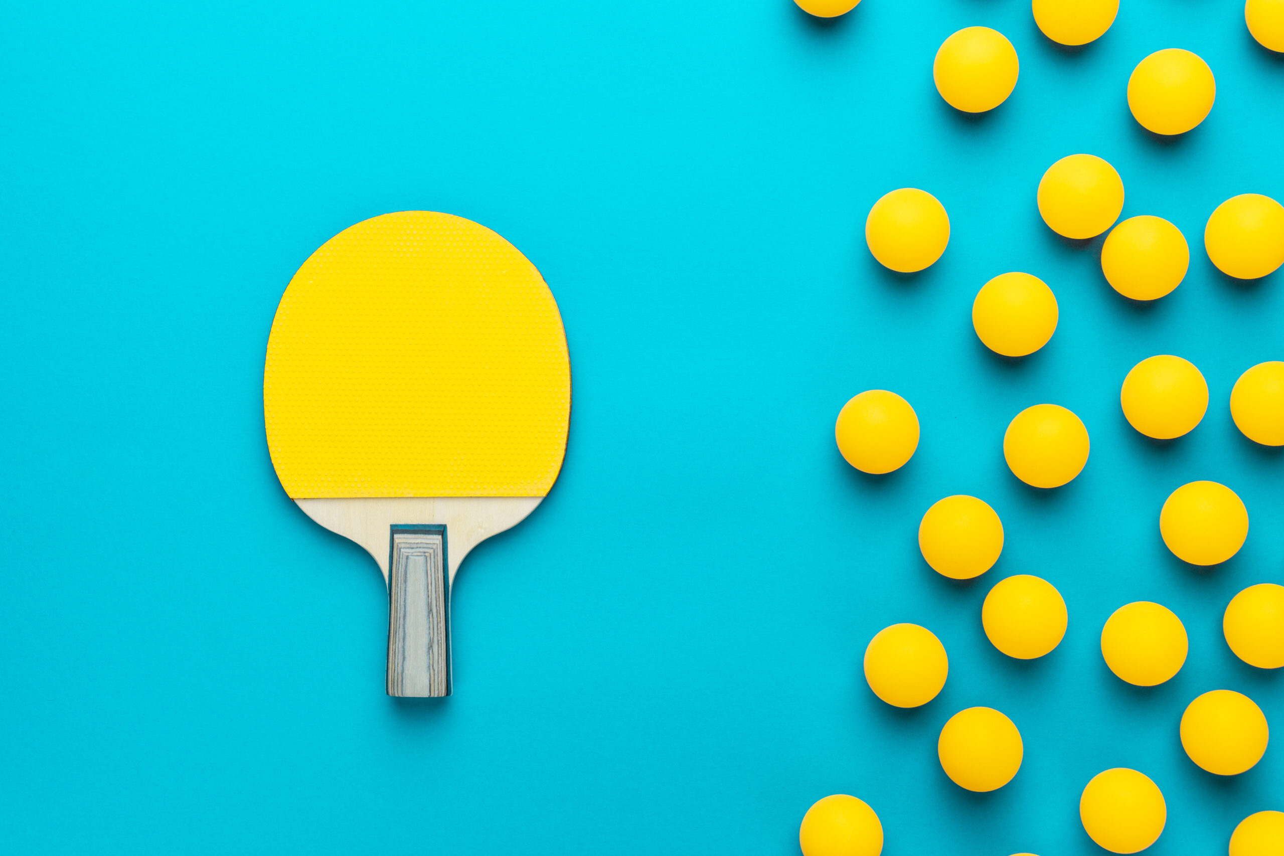 yellow ping pong ball and paddle